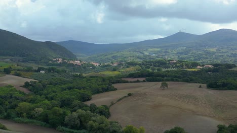 Stunning-aerial-top-view-flight-Tuscany-meditative-valley,-village-Italy-fall-23