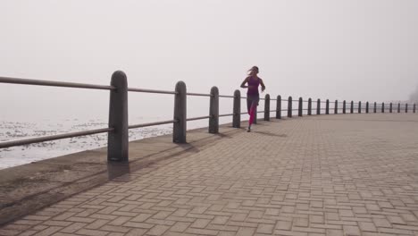 Caucasian-woman-running-on-the-docks