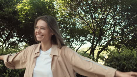 woman walking through bushes in park