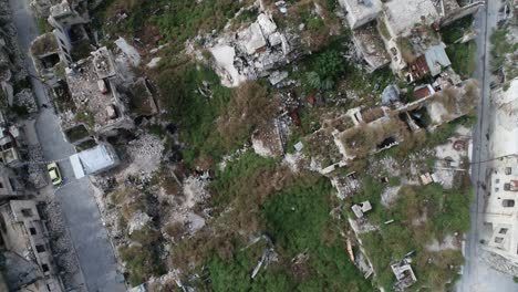 rooftops of buildings in ruins of the ancient city in the middle of aleppo in syria, even after the war - aerial view with a drone 4k