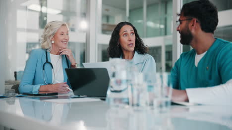 a group of doctors are having a meeting in an office.