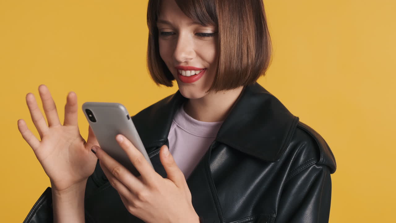 Happy woman watching funny video on smartphone