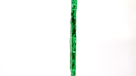 Green-water-pouring-across-white-background