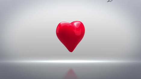 red heart turning and exploding on grey background