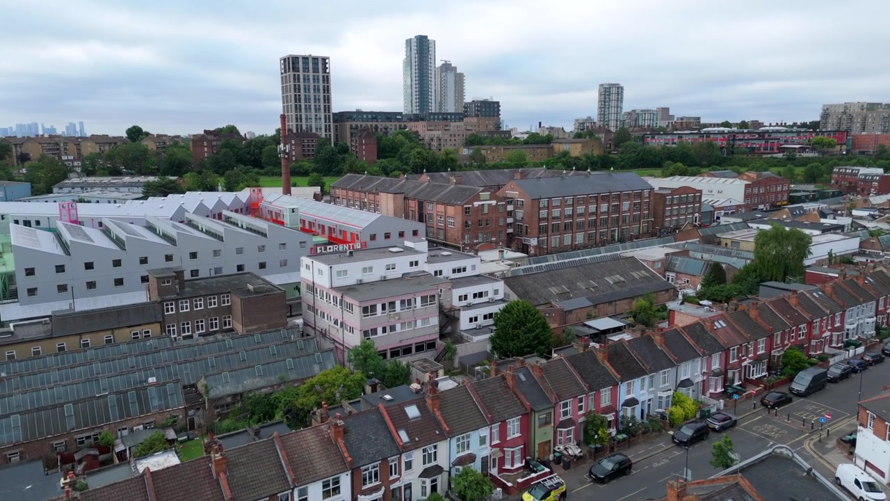 Drone Shot of Old Terraced Houses Beside New Build Apartment Towers, England