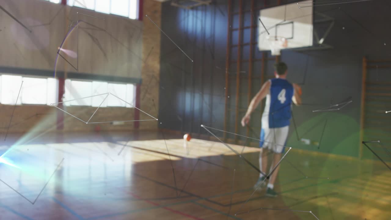 Camera pulling back revealing male #4 dribbling orange ball to score in sports gym overlays flaring