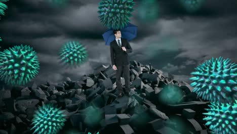Multiple-covid-19-cells-floating-over-businessman-holding-an-umbrella-standing-on-broken-rocks