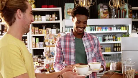 camarera sirviendo una taza de café al cliente
