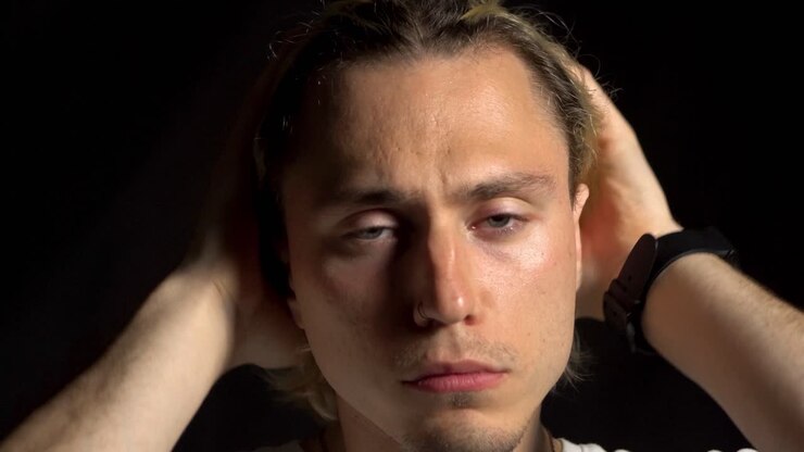 Close up portrait of frustrated, sad young blond man