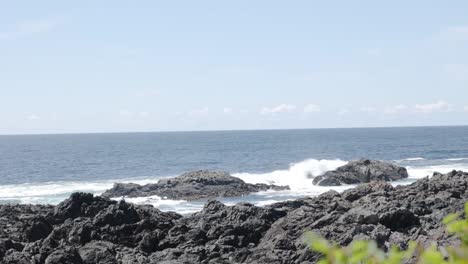 A-slow-motion-handheld-video-of-waves-crashing-against-the-rocks-on-the-ocean-coast