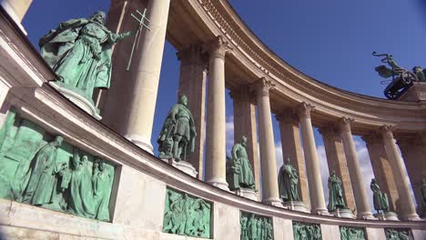 establishing shot of statues in heroes square in budapest hungary