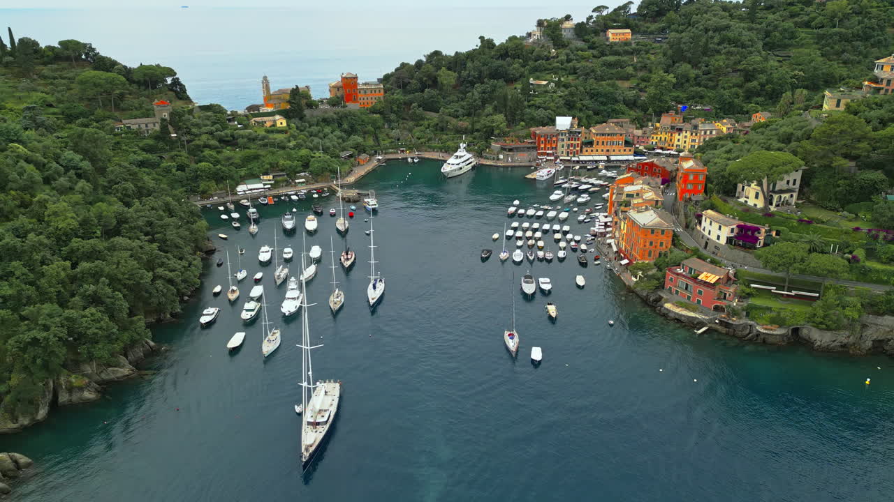 Portofino, renowned coastal town in Liguria, Italy, features its iconic harbor filled with yachts and boats