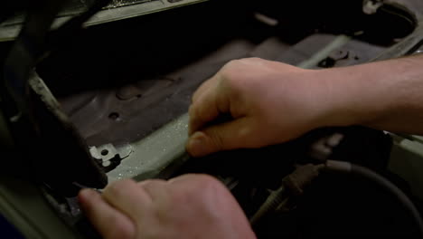 mechanic worker fix and changes the brake system for a car