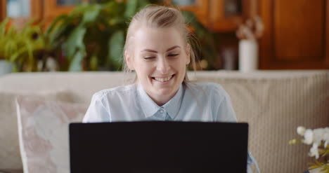 smiling woman working on laptop at home office 2