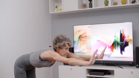 senior woman doing online dance class at home