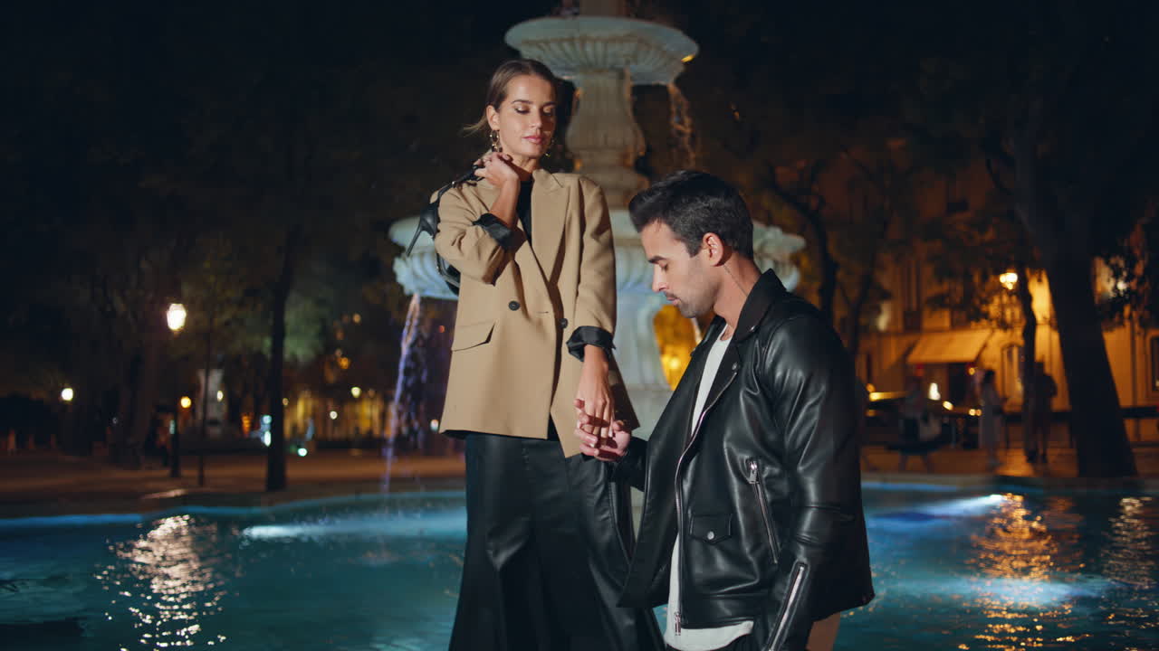 Urban couple resting city at night. Stylish models posing together on street