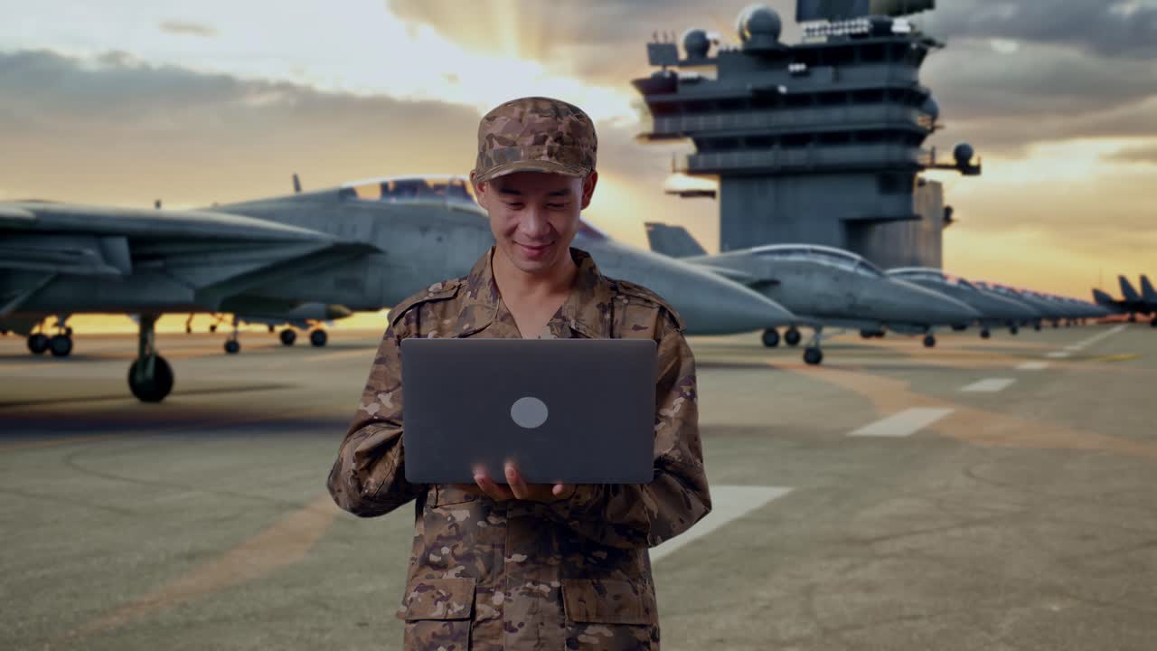 Military Personnel with Laptop on Aircraft Carrier Deck