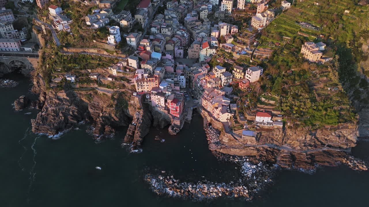 Riomaggiore, cinque terre with colorful houses on rocky coastal cliffs, aerial view