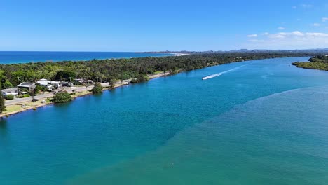 boat travels along scenic tweed river, australia