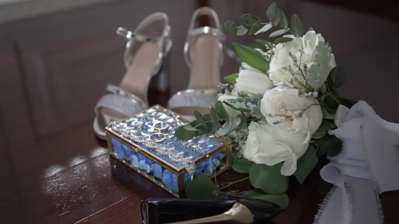 bridal bouquet with shoes and elegant box arranged for wedding preparation