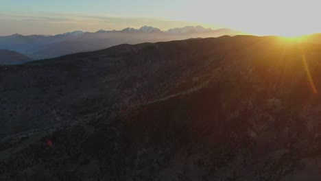 greek mountains with sunset in the background