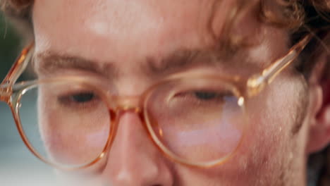 close-up of a man's face with eyeglasses