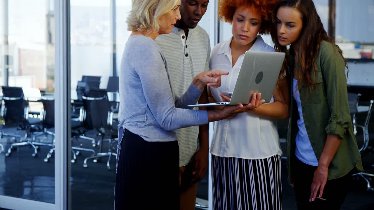 Dirigenti che discutono davanti a un laptop in ufficio