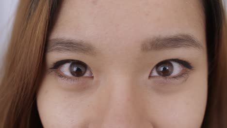 close up of middle eastern young woman face, the girl has beautiful brown eyes, she smiles