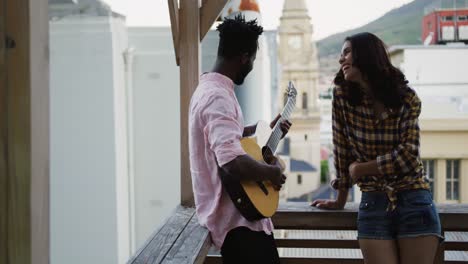 young adult friends hanging out on a rooftop