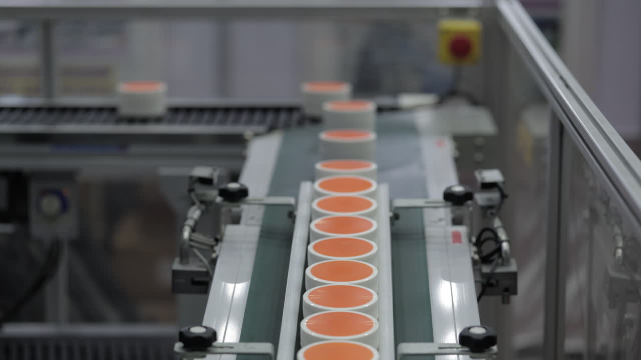 Cream jars on a conveyor belt