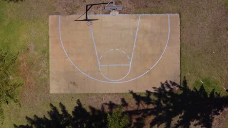 top down aerial view of rural basketball half court in australian countryside