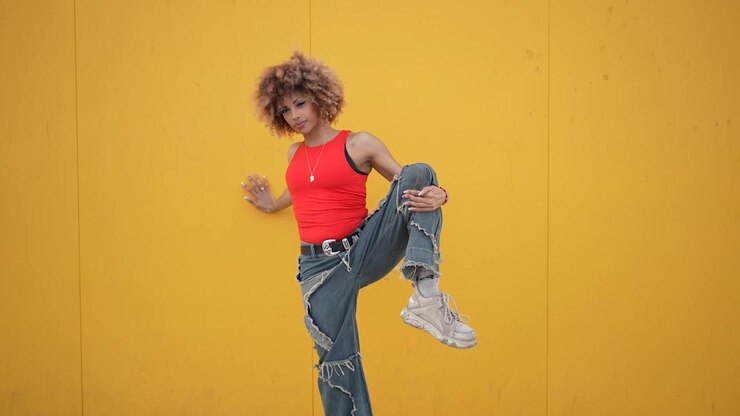 A striking and dynamic fashion pose set against a vibrant and eyecatching yellow background