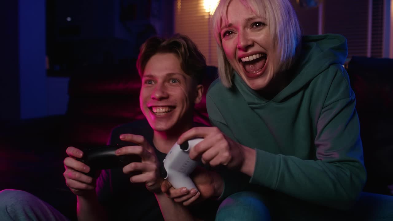Young caucasian couple playing video game with game pads
