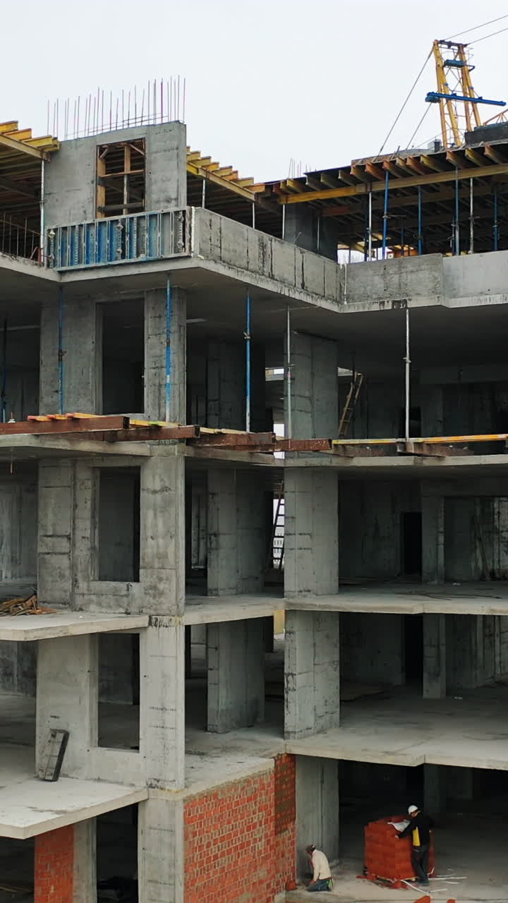 Building In The Process Of Construction. Construction site with bird eye in megacity