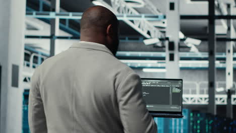 vertical video programmers walking in data center coding, doing optimizations using tablet