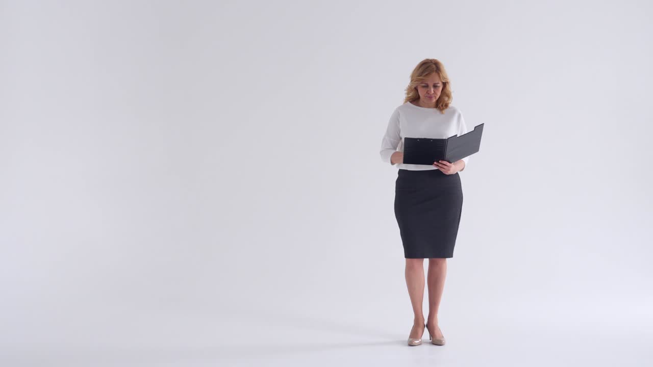 Businesswoman looking documents in folder