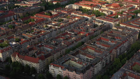 Aerial-view-of-blocks-of-tenement-houses-in-urban-neighbourhood.-Building-facades-illuminated-by-bright-afternoon-sun.-Berlin,-Germany