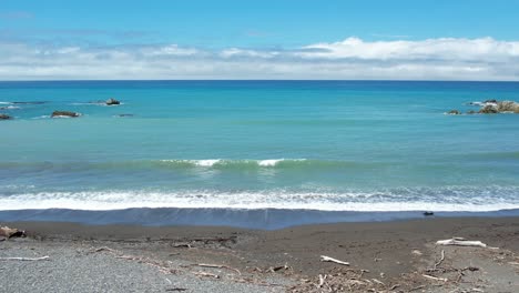 drone descending slowly and approaching ocean waves faster