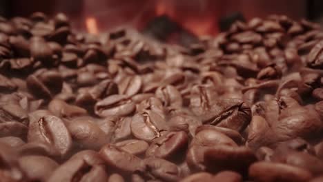 Close-up-of-seeds-of-coffee.-Fragrant-coffee-beans-are-roasted-smoke-comes-from-coffee-beans.