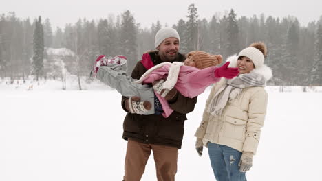 happy family playing in the snow