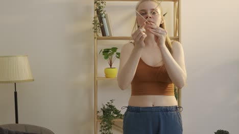 young woman dancing in living room