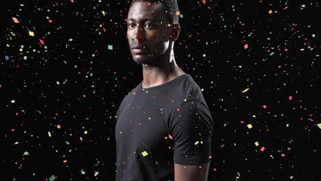 animation of confetti falling over african american male athlete on black background