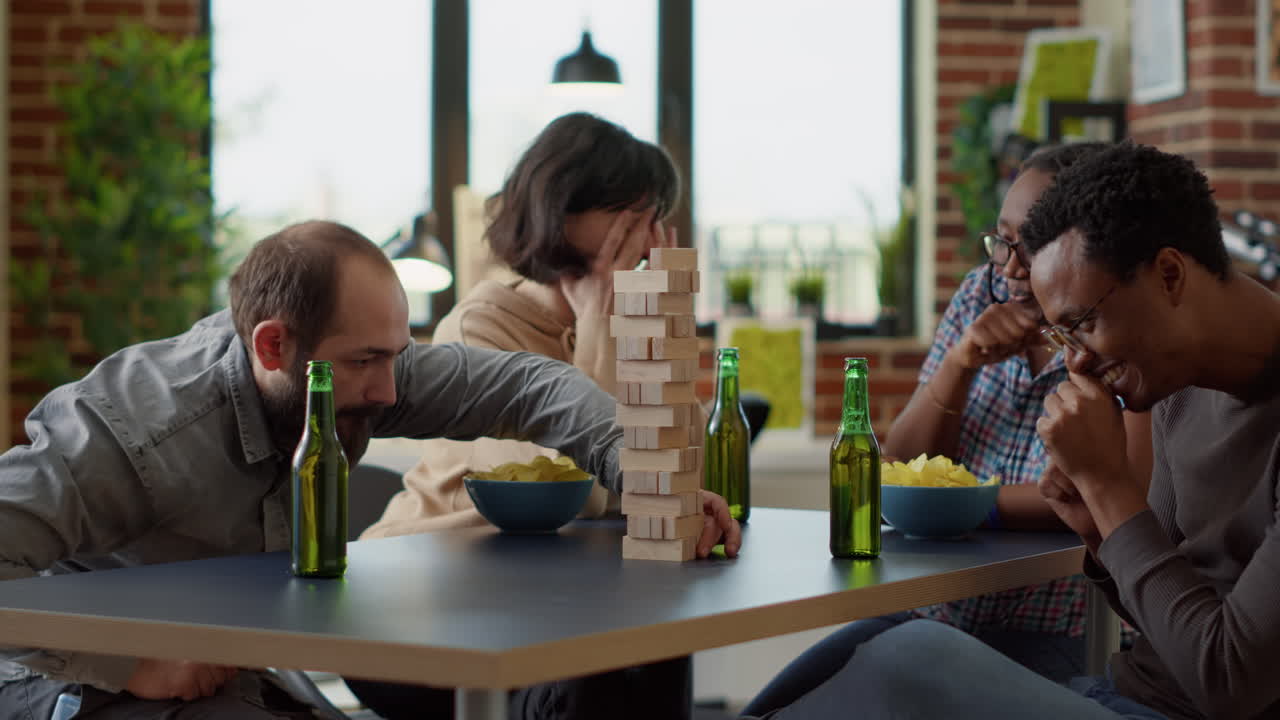 Men and women playing board games with tower cubes