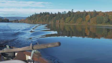 autumn woodland colours seen from rowboat rack focus from oarlock