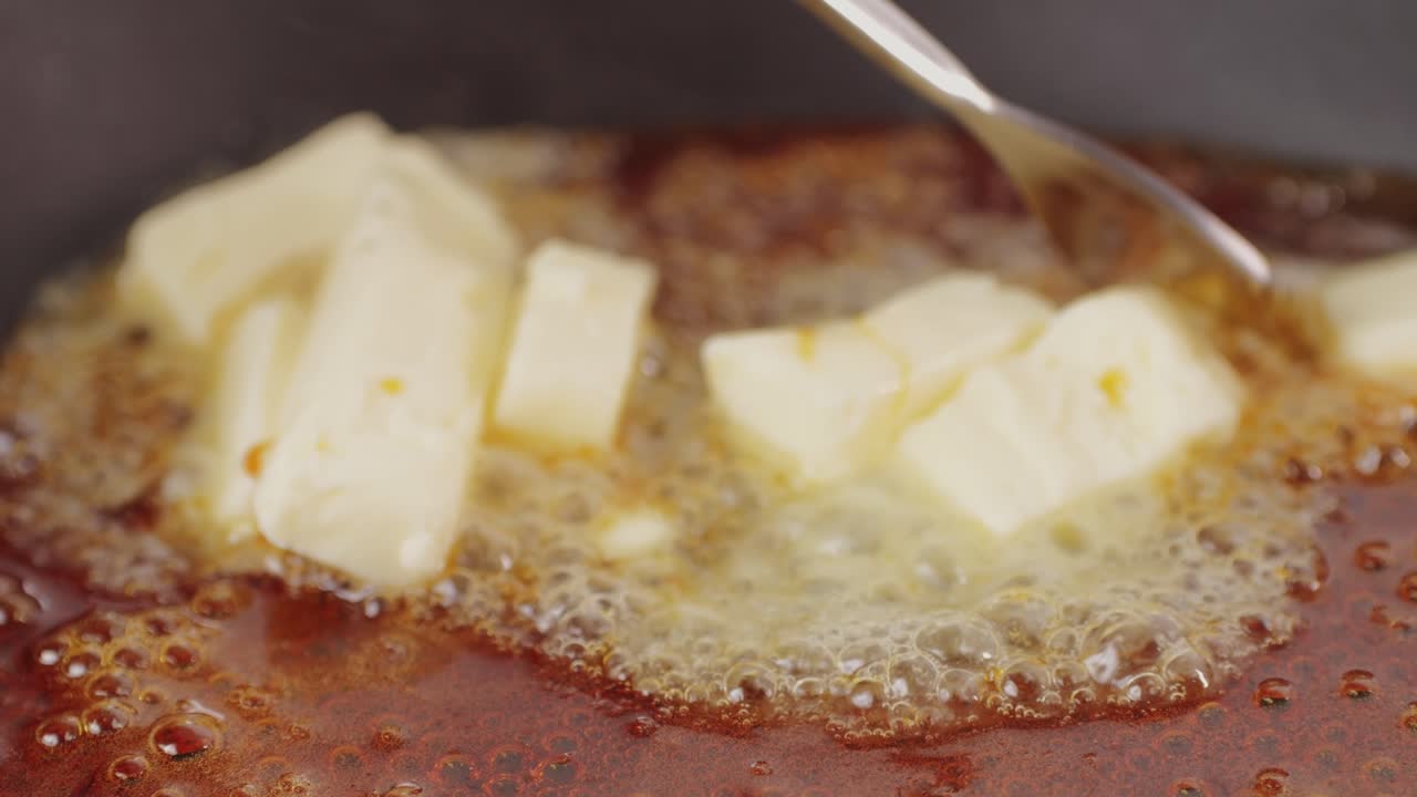 Close up of boiling sugar with bubbles turns into caramel, caramelization, chef cooking dessert in cafe, restaurant pastry food.