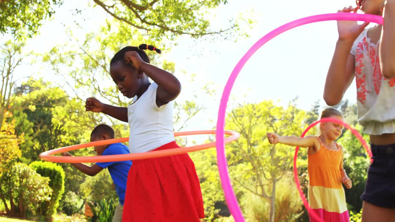 Group of kids twirling hula hoop