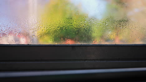 dolly right shot of condensation on house window