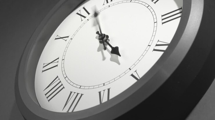 Latin Clock Face in Time Lapse on Dark Grey Wall