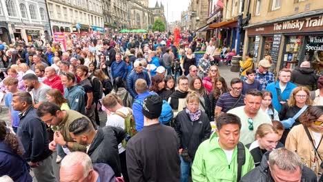 large crowd gathered on cockburn street, edinburgh