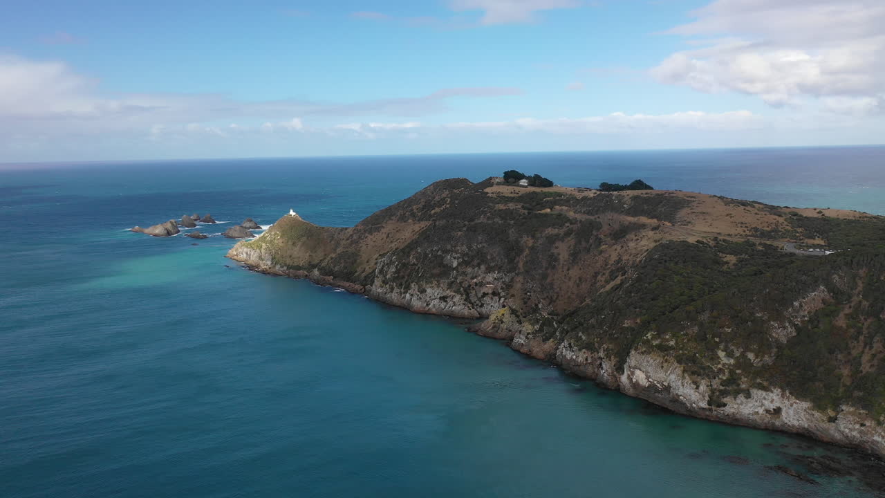 Picturesque aerial view of Nugget Point Lighthouse along the stunning coast of New Zealand's South Island